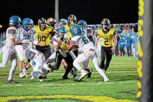 Bentworth’s Ben Hays (22) is stacked up by Jeannette’s Nick Mendoza (6) and Maji Sanders (4) during their WPIAL first-round playoff game Friday, Oct. 31, 2025.