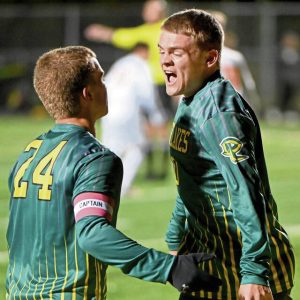 Deer Lakes’ Peyton Kushon celebrates his goal with Jacob Orseno during their PIAA Class 2A playoff game against Harbor Creek on Tuesday in West Deer.