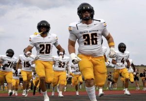 Thomas Jefferson’s Deacon Kamberis (36) and Jarrett Becoate (20) take the field with their teammates before their game on Friday, Sept. 5, 2025, at McKeesport.