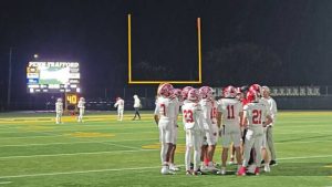 Moon players huddle up before a WPIAL Class 5A quarterfinal game Nov. 7, 2025, at Penn-Trafford.