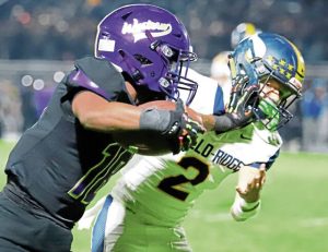 Western Beaver’s Jeremiah Pratt stiff-arms Apollo-Ridge’s Gage Wingard during a long run in the second quarter of a WPIAL Class 2A quarterfinal Friday night.