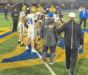 Players from Canon-McMillan and Central Catholic meet at midfield for the coin toss before their WPIAL Class 6A semifinal Friday at West Mifflin.