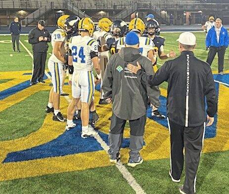 Players from Canon-McMillan and Central Catholic meet at midfield for the coin toss before their WPIAL Class 6A semifinal Friday at West Mifflin.