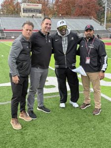 Moon school board member Adam Gill, superintendent Jason D’Alesio, Colorado coach Deion Sanders and athletic director Alan Alcalde pose for a photo while Colorado was at Moon for practice Friday.