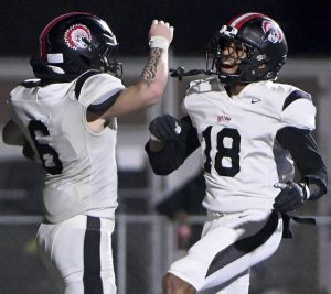 Aliquippa’s J.J. Work (6) celebrates with Zion Simmons after scoring against New Castle during their WPIAL Class 4A semifinal Friday at Helling Stadium in Ellwood City.