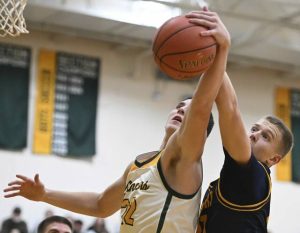 Deer Lakes’ Nate Moore and Freeport’s Michael Graczyk battle for a rebounds Dec. 13, 2024.