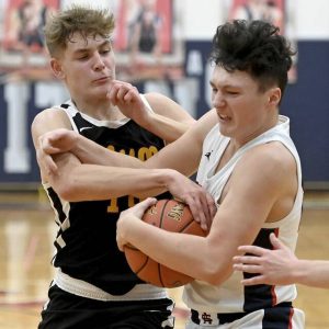 Shaler’s Julian Vizzoca and Plum’s Owen Proskin battle for a loose ball Jan. 3, 2024, at Shaler.