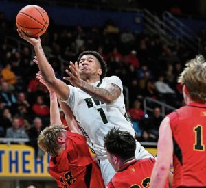 Belle Vernon’s Curtis Wade drives over North Catholic’s Donnie Schubert and Joe Waskiewicz during the WPIAL Class 4A championship game Feb. 27 at Petersen Events Center.