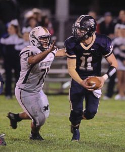 Freeport’s Ryan Weigold (11) eludes a McGuffey defender on Nov. 6, 2015 in the final game at James Swartz Memorial Stadium. Weigold was 22-of-24 passing for 353 yards and five touchdowns in a 45-6 Yellowjackets victory.