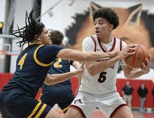 Central Catholic’s Xxavier Thomas defends on Fox Chapel’s John Rehak during WPIAL quarterfinal action Thursday, Feb. 20, 2025 at Fox Chapel Area High School.