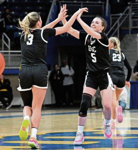Upper St. Clair’s Ryan Prunzik (5) celebrates with Rylee Kalocay during the WPIAL Class 6A championship game against Norwin on March 1 at Petersen Events Center.