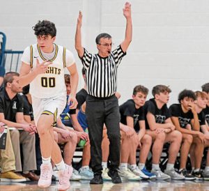 Norwin’s Nate Kuch (left) reacts after hitting a 3-pointer against Hempfield last season.