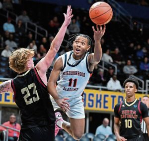 Neighborhood Academy’s Kedron Gilmore drives on Serra Catholic’s Tyler Sapida during the WPIAL Class A championship game Feb. 27 at Petersen Events Center.