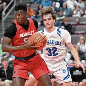 Sewickley Academy’s Mamadou Kane pulls down a rebound in front of Linville Hill’s Stephen Smucker during the PIAA Class 2A championship game March 28 at Giant Center in Hershey.
