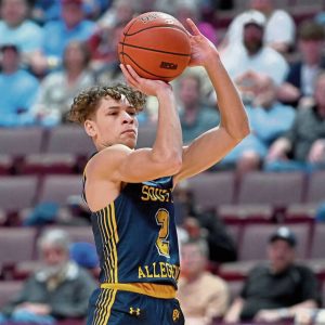 South Allegheny’s Drew Cook shoots a 3-pointer against West Catholic defenders during the PIAA Class 3A championship game March 29 at Giant Center in Hershey.