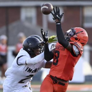 Clairton’s Brandon Murphy Jr. catches a pass over Imani Christian’s David Davis on Aug. 22.