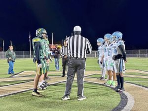 Players from Washington and Seton LaSalle meet at midfield for the coin toss before their game Oct. 24, 2025, at Dormont Stadium.