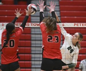 Pine-Richland’s Elanyse Hernandez hits against Peters Township’s Angelina Williams and Alex Knox during the WPIAL Class 4A volleyball championship Nov. 1, 2025 at Peters Township High School.