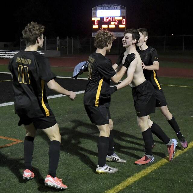 Bentworth’s Adam Moessner is mobbed by teammates after scoring in overtime to defeat Delco Christian in the PIAA Class A championship game Saturday at Northeastern York High School.
