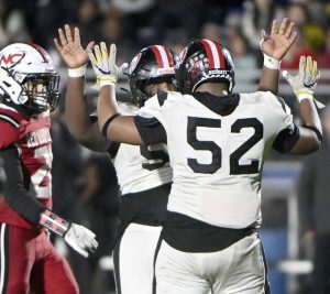 Aliquippa’s Mylez Greene celebrates with Justus Starks after a tackle for loss against New Castle during their WPIAL Class 4A semifinal on Friday, Nov. 7, 2025, at Helling Stadium in Ellwood City.