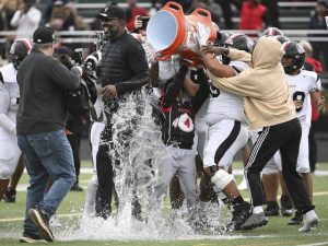 Aliquippa head coach Mike Warfield gets soaked with water after beating McKeesport in the WPIAL Class 4A football championship Saturday Nov. 15, 2025 at Pine-Richland.