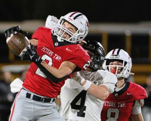 Peters Township’s Lucas Rost hauls in an interception against Upper St. Clair on Friday. The Indians won and will play in the WPIAL final Saturday against Pine-Richland.