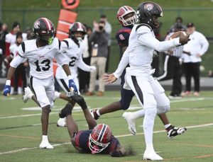 Aliquippa quarterback Marques Council Jr. avoids McKeesport’s Kemon Spell on the way to a touchdown during the WPIAL Class 4A championship game Saturday at Pine-Richland.