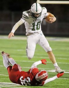 Laurel’s Jack Miles leaps over Fort Cherry’s Jordan Bianchi during the first half of the Spartans’ 24-14 win in the WPIAL Class A semifinals Friday at Tony Dorsett Stadium at Hopewell.