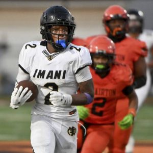 Imani Christian’s David Davis eludes Clairton defenders on a second-quarter touchdown run Aug. 22.