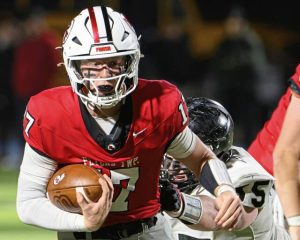Peters Township quarterback Nolan DiLucia (17) looks for room to run against Upper St. Clair on Friday, Nov. 14, 2025, at Canon-McMillan.