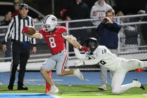 Peters Township’s Cole Neupaver (8) scores on a run against Upper St. Clair last Friday at Canon-McMillan.