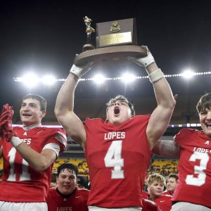 Avonworth’s Luca Neal hoists the WPIAL championship trophy after the Antelopes defeated Imani Christian in the Class 3A final on Saturday, Nov. 22, 2025, at Acrisure Stadium.