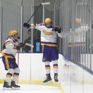 Plum’s A.J. Leah celebrates against the glass next to Colby Bartos after scoring against Greensburg Salem on Monday, Nov. 24, 2025, at Pittsburgh Ice Arena.