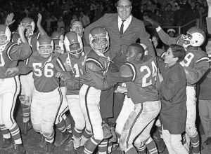 The jubilant Oakmont Oaks carry coach Chuck Wagner off the field at Ken High Memorial Stadium moments after winning the WPIAL Class B title, 26-13, over Apollo on Nov. 19, 1965. Celebrating are Rich Scholl (56), Marshall Pollard (17), Terry Preece, Vince Taylor (24), team manager Denny Bonaroti and Sherron Montague.