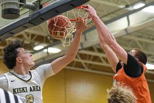 Latrobe’s Ian DeCerb throws down a dunk over Kiski Area’s Landyn Artman last season.