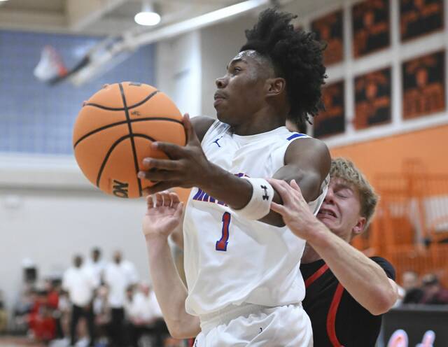Jeannette’s Kymon’e Brown is fouled by Indiana’s Will Olsen on Friday at Greater Latrobe High School.