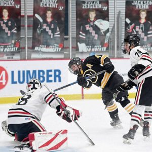 Quaker Valley’s Max Modrovich puts a shot on Moon goalie Tyler Zeigler during their game on Monday, Nov. 24, 2025, at RMU Island Sports Center.