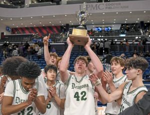 Lukas Stead (42) hoists the 2025 City League championship trophy as the Allderdice boys basketball team celebrates after beating Obama Academy on Sunday, Feb. 16, 2025, at UPMC Cooper Fieldhouse.