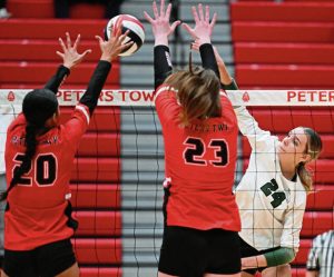 Pine-Richland’s Elanyse Hernandez hits against Peters Township’s Angelina Williams and Alex Knox during the WPIAL Class 4A volleyball championship Nov. 1.