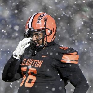 Clairton’s D’Kota Harris wipes away the snow between plays during the Bears’ PIAA Class A semifinal against Greenville on Friday, Nov. 28, 2025, at Helling Stadium in Ellwood City. (Christopher Horner | TribLive)