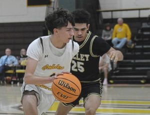 Greensburg Salem’s Solomon Cain drives around Valley’s Leonidus Moore on Wednesday. (Paul Schofield | TribLive)