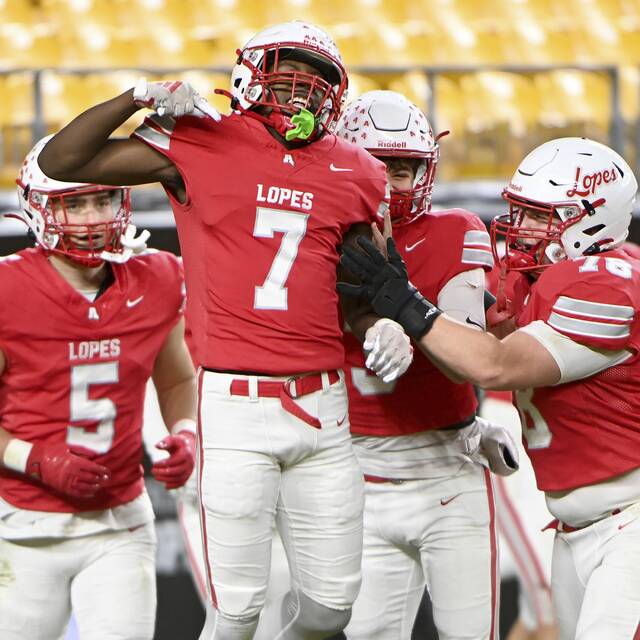 Avonworth’s Romello Harris celebrates his pick-6 against Imani Christian with teammates during the WPIAL Class 3A championship game on Saturday, Nov. 22, 2025, at Acrisure Stadium. (Christopher Horner | TribLive)