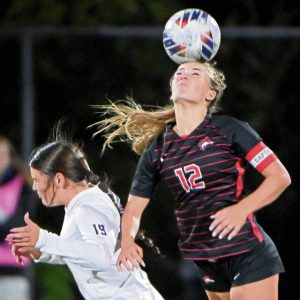 Fox Chapel’s Emily McKee heads the ball over Plum’s Madi Stewart during their WPIAL Class 3A semifinal on Monday, Oct. 27, 2025, at Gateway. (Christopher Horner | TribLive)