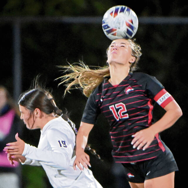 Fox Chapel’s Emily McKee heads the ball over Plum’s Madi Stewart during their WPIAL Class 3A semifinal on Monday, Oct. 27, 2025, at Gateway. (Christopher Horner | TribLive)