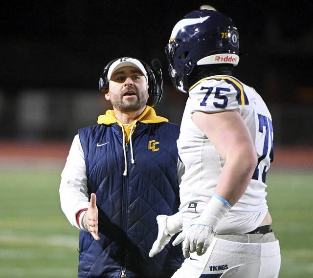 Central Catholic head coach Ryan Lehmeier celebrates with Jon Sassic after scoring against Harrisburg during their PIAA Class 6A semifinal on Saturday, Nov. 29, 2025, at Mansion Park in Altoona. (Christopher Horner | TribLive)