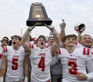 Avonworth’s Luca Neal hoists the state championship trophy with Carson Belliner and Cooper Scharding with their teammates after defeating Northwestern Lehigh in the PIAA Class 3A final on Saturday, Dec. 6, 2025, at Cumberland Valley. (Christopher Horner | TribLive)