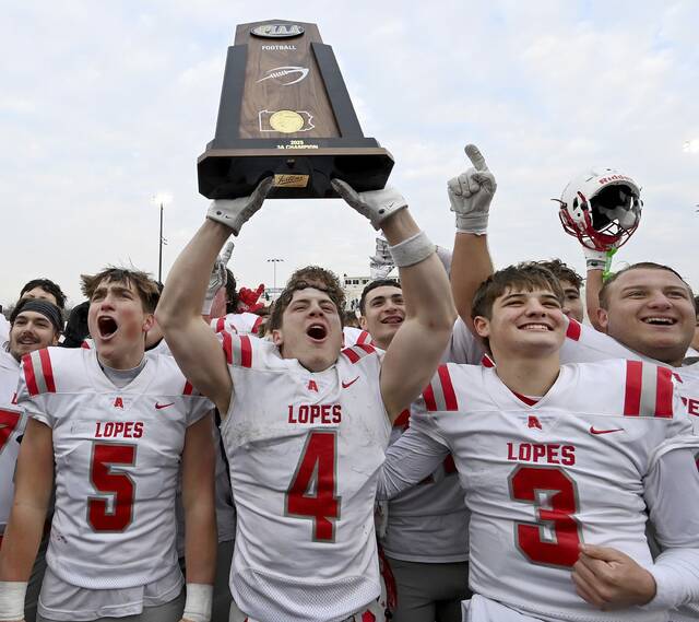 Avonworth’s Luca Neal hoists the state championship trophy with his teammates after defeating Northwestern Lehigh in the PIAA Class 3A final on Saturday, Dec. 6, 2025, at Cumberland Valley. (Christopher Horner | TribLive)