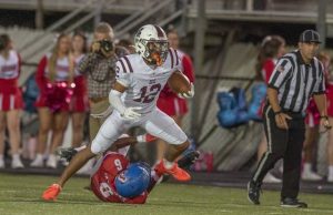 Greensburg Central Catholic’s Samir Crosby breaks the tackle of Jennette’s Anthony Stuchell and runs for a touchdown earlier this season. (Louis B. Ruediger | TribLive)