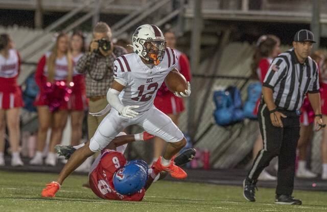 Greensburg Central Catholic’s Samir Crosby breaks the tackle of Jennette’s Anthony Stuchell and runs for a touchdown earlier this season. (Louis B. Ruediger | TribLive)