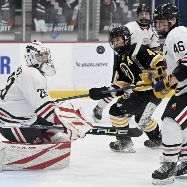 Moon goalie Tyler Zeigler makes a save on Quaker Valley’s Max Modrovich during their game on Monday, Nov. 24, 2025, at RMU Island Sports Center. (Christopher Horner | TribLive)